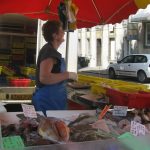Fisherwoman selling fish at a stall